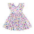 Load image into Gallery viewer, The Block Party (Purple) Short Sleeve Big Kid Twirl Dress by Big Dreams Little Jammies is a white, hypoallergenic dress with ruffled sleeves and a colorful cartoon soap bar print in pink, yellow, blue, and purple.