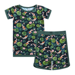 The Jammie Session Bundle of Koi Short Pajama Set is a breathable, hypoallergenic kids' pajama with a koi fish, lily pad, and lotus flower print on dark green; includes short sleeves and matching shorts.